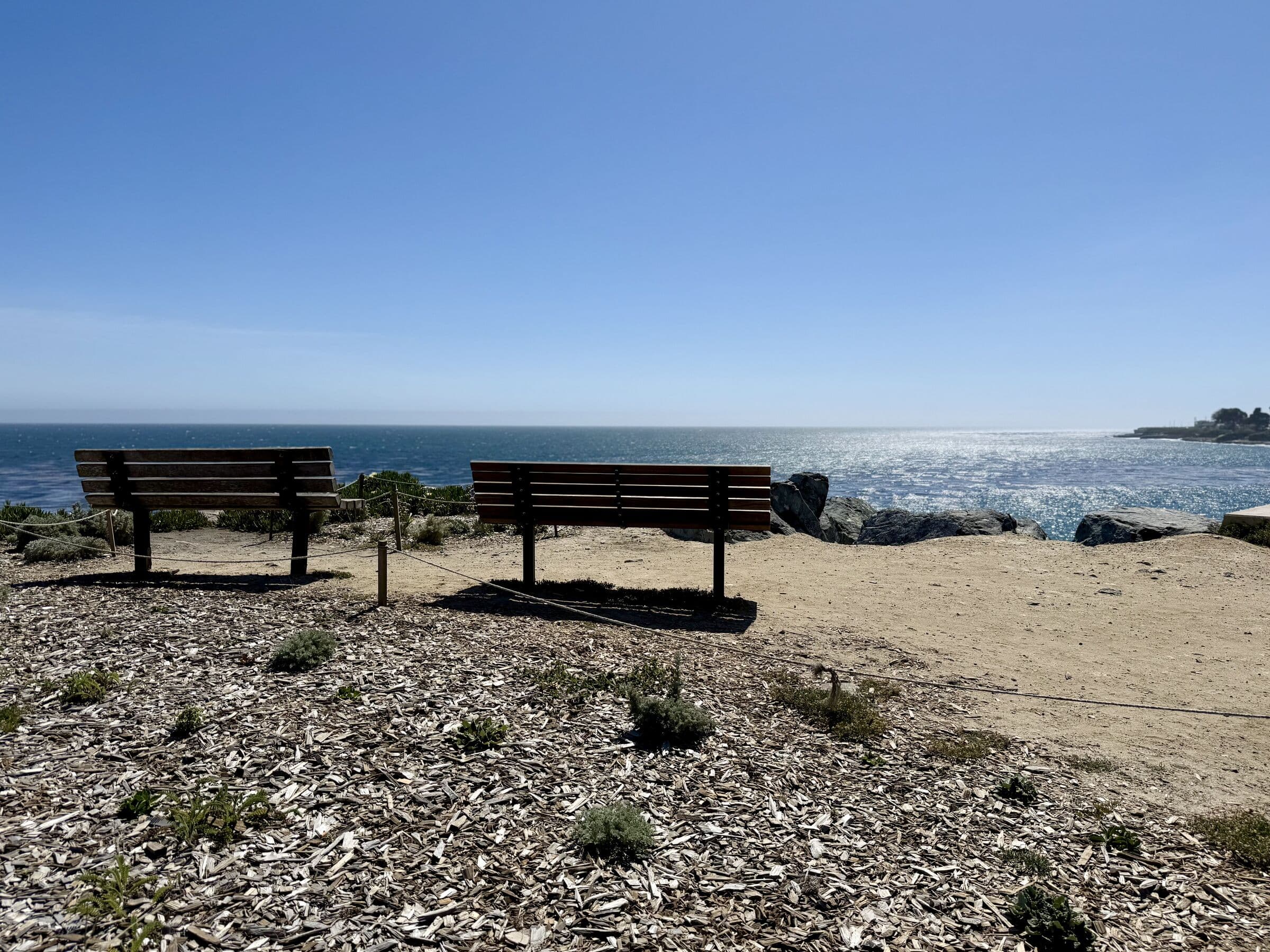 Two wooden benches overlooking the Pacific Ocean in Santa Cruz